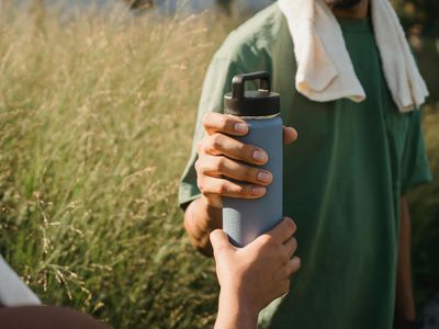 Close up of a water bottle and a towel.