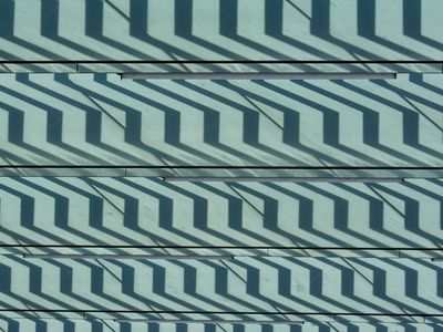 Shadow of a person moving rhythmically on a wall.